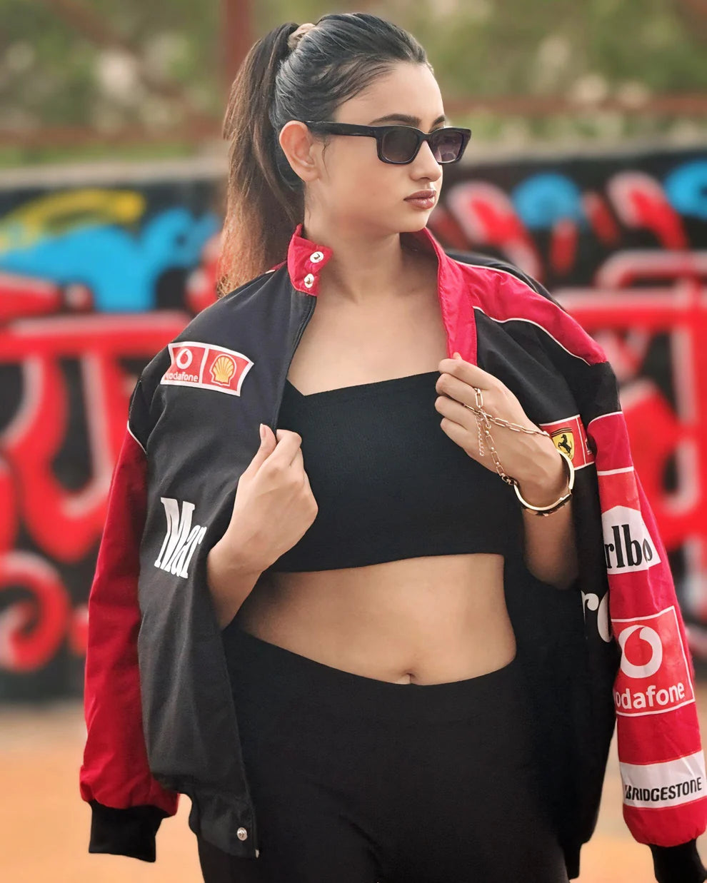Marlboro Racing Puffer Jacket – Motorsport Luxury Edition styled with black crop top and leggings, showcasing bold sponsor logos and sleek design.