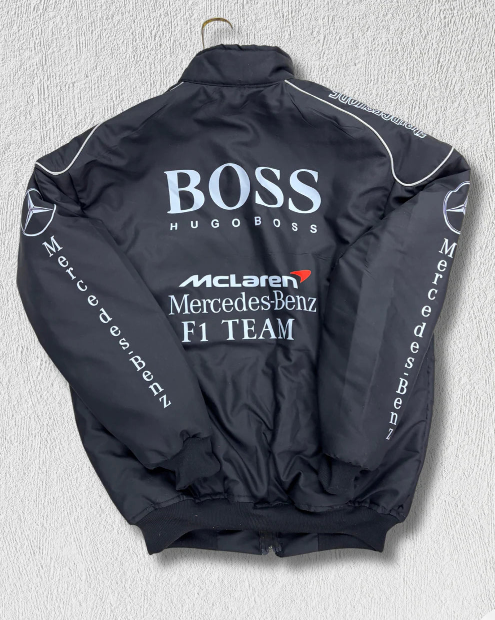 Back view of McLaren Racing Puffer Jacket with bold Hugo Boss, McLaren, and Mercedes-Benz F1 Team branding, ideal for motorsport streetwear fans.