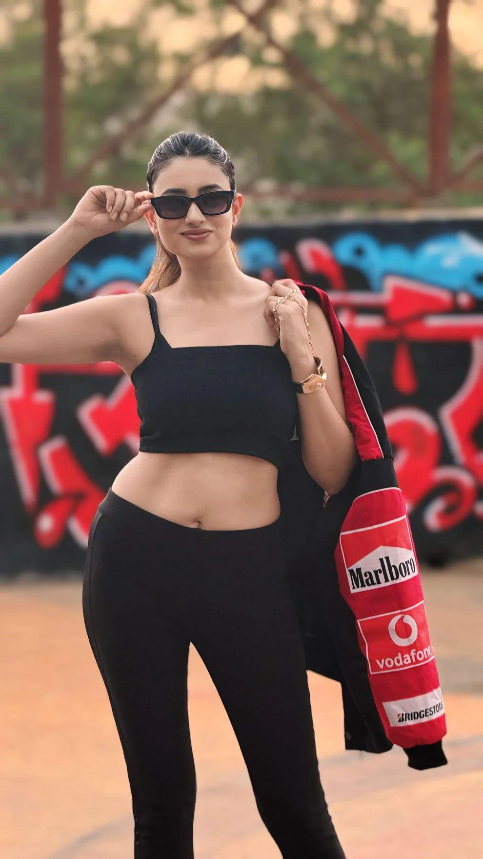 Front view of Marlboro Racing Puffer Jacket – Motorsport Luxury Edition paired with black outfit, emphasizing stylish motorsport branding and fit.