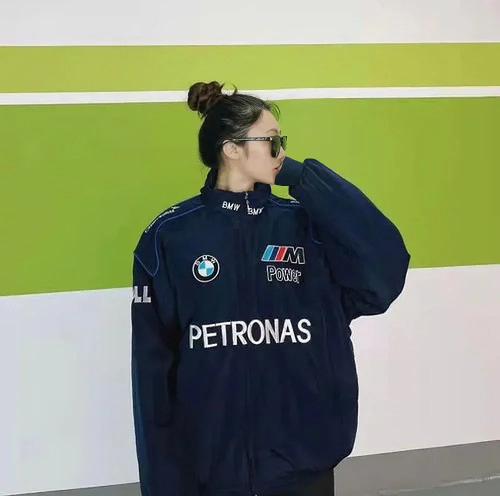 Model wearing BMW Petronas F1 Racing Jacket, showcasing unisex fit and bold branding ideal for racing enthusiasts and streetwear lovers.