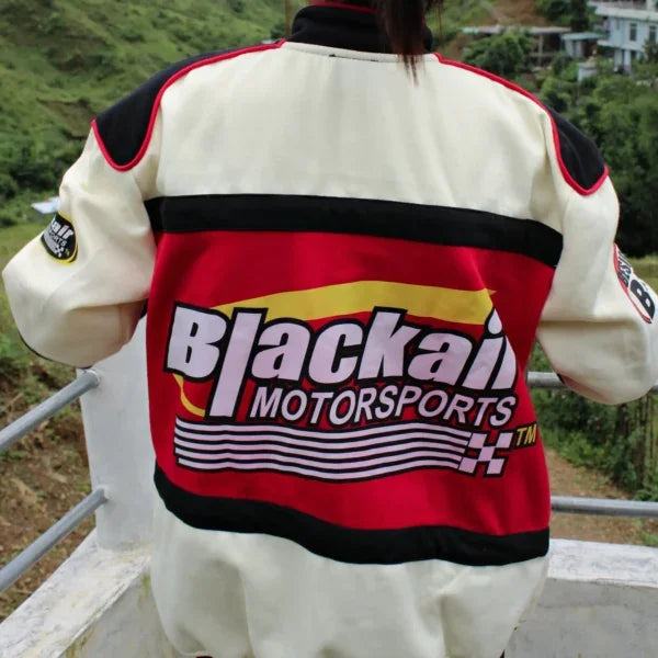 Back view of Racing Icon Jacket - Unisex Vintage featuring large Blackair Motorsports logo and racing-inspired graphics in red, yellow, and white.